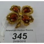 An 18ct gold brooch, fashioned as a flower,