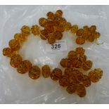 An amber bead necklace with ribbed decoration 11
