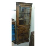 A modern George III inspired oak corner cabinet with a glazed door and a panelled door,