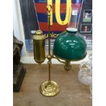 An early 20thC brass student's desk lamp, on a circular, stepped plinth,