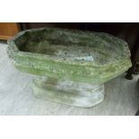 A composition stone garden planter of squat, octagonal form,