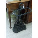 An early 20thC cast iron stickstand with a removable reservoir 26''h RSF