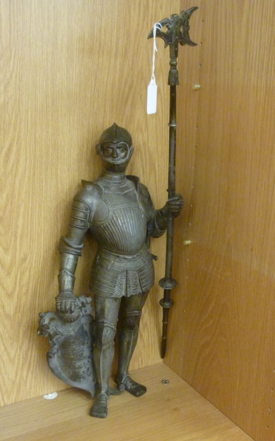 A modern cast and patinated metal figure, a soldier in full armour,