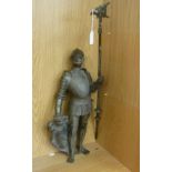 A modern cast and patinated metal figure, a soldier in full armour,