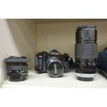 A Canon A1 camera body and three lenses, viz. 28mm 1.2.8; a 24mm 1.28; and a 200mm 1.