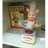 A 1960s Japanese tinplate battery operated 'Piggy Cook' a pig cooking a pancake 10''h boxed