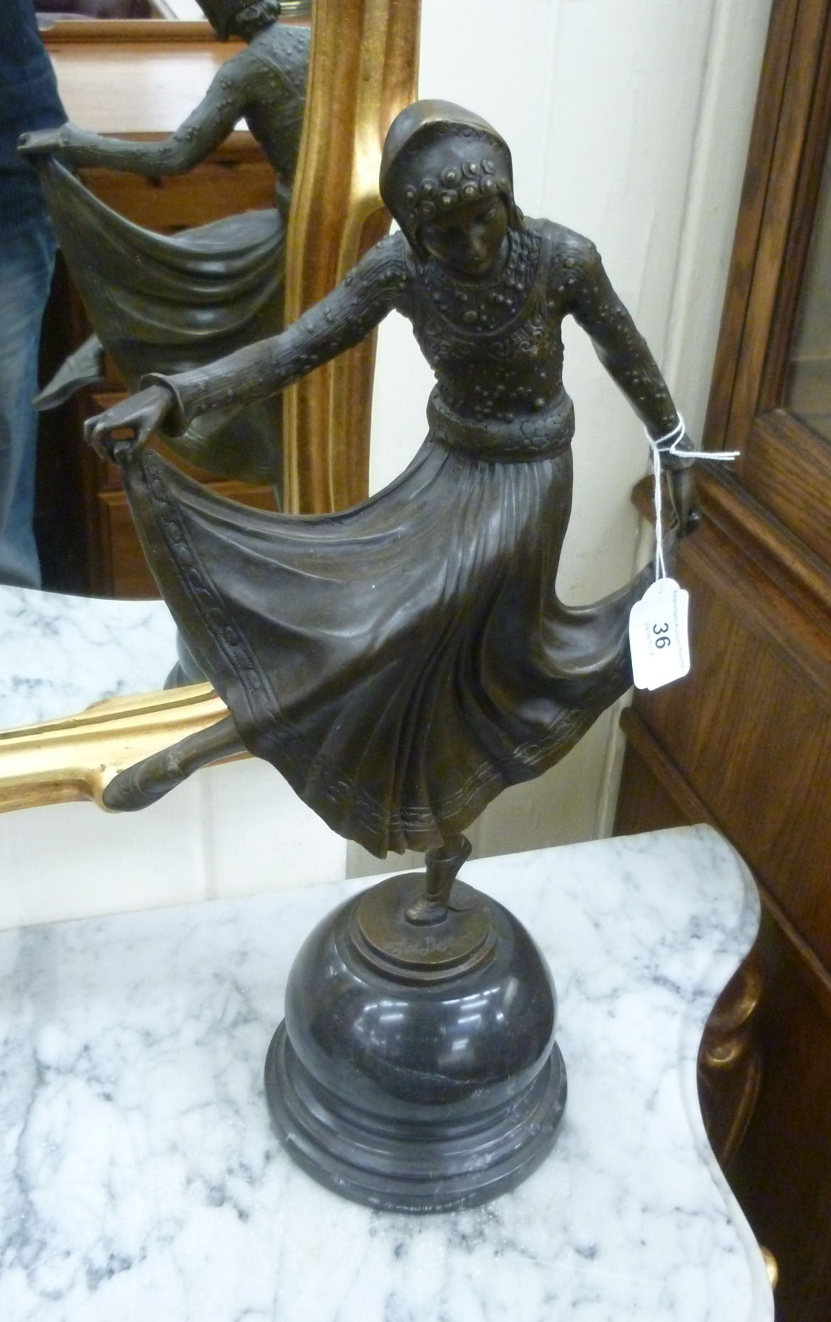 A cast and patinated bronze figure, an Art Deco style woman dancing,