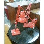 A pair of modern red painted metal anglepoise table lamps F
