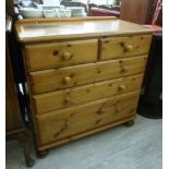 A Ducal pine five drawer dressing chest, raised on turned,