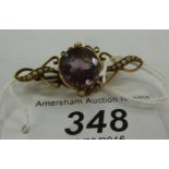 A 15ct gold brooch, set with an amethyst,