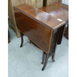An Edwardian mahogany Sutherland table, the crossbanded top raised on square,