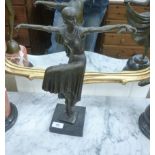 A cast and patinated bronze figure, an Art Deco style woman dancing, on a plinth 16.