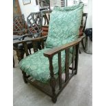 A 1930s oak framed reclining armchair with upholstered back and seat, raised on baluster turned,