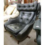 A 1960s arm chair, part button upholstered in black vinyl,