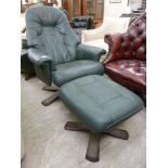 A modern swivel armchair, upholstered in a green hide,