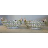 A pair of late 19thC Dresden porcelain baskets, each with opposing twin handles and latticed sides,