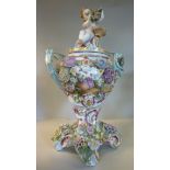 A late 19thC Dresden porcelain vase and cover of baluster form, surmounted by a cherub,