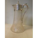 A mid Victorian cut glass claret jug with an applied silver handle, collar,