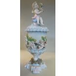 A late 19thC Continental porcelain vase and cover of cylindrical form with a cherub finial,