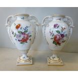 A pair of late 19thC Continental porcelain vases of ovoid pedestal urn design,