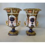 A pair of Royal Crown Derby china vases, each fashioned as a campana design urn,