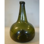 A late 17th/early 18thC Onion design green glass bottle with a tapered stem and bulbous body bears