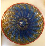 A Kosta-Boda art glass Peacock pattern shallow bowl, decorated in tones of blue,