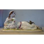 A Rosenthal porcelain R Forster figure, a reclining woman holding a rose,