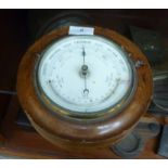 An early 20thC cushion moulded, mahogany cased aneroid barometer with a printed dial 7.