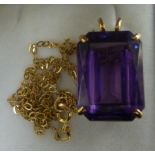 A 9ct gold pendant, set with an amethyst coloured stone,