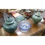 A matched pair of streaky green and blue glazed earthenware vases of squat,