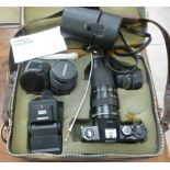 A Miranda 35mm camera with a zoom lens and accessories CA