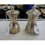 A silver pepper mill of traditional design with a cast gadrooned base Birmingham 1972;