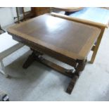 A 1920s stained oak draw leaf dining table, the top having rounded corners, raised on bulbous,