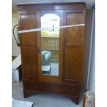 An Edwardian ebony string inlaid and marquetry mahogany wardrobe with a moulded cornice,