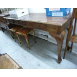 A modern teak hall table, the planked top over three in-line box drawers,