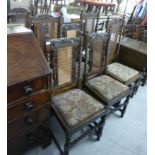 A matched set of eight 1920/30s oak framed dining chairs, each with a caned, panelled back,