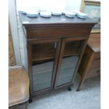 An Edwardian crossbanded and string inlaid mahogany bookcase with a pair of glazed doors,