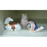 Three Royal Crown Derby bone china paperweights with stoppers, viz. a snail 2.