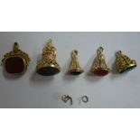 Four yellow metal pendant seals, variously set with coloured stones,