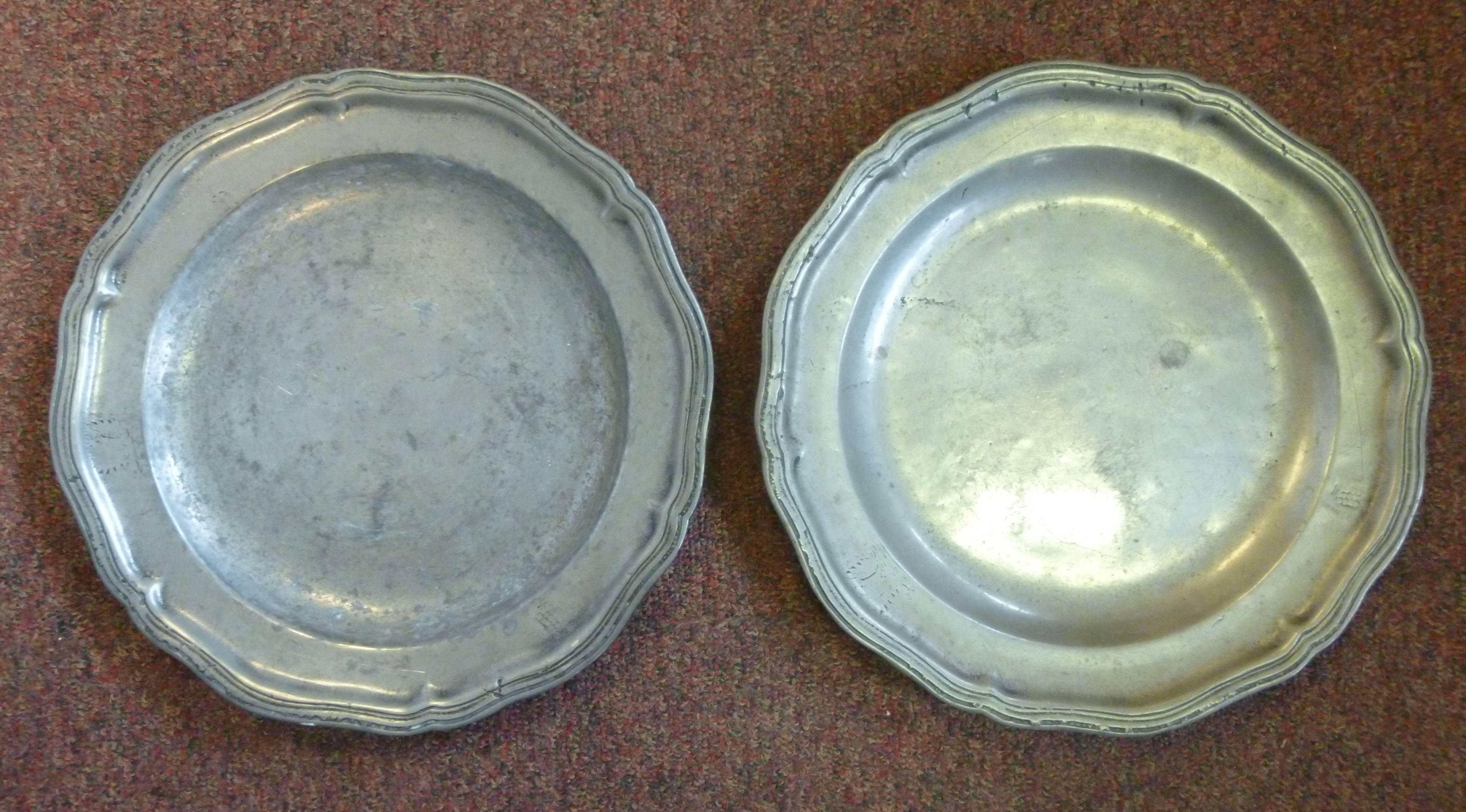 A pair of 18thC pewter plates with wavy borders 11.