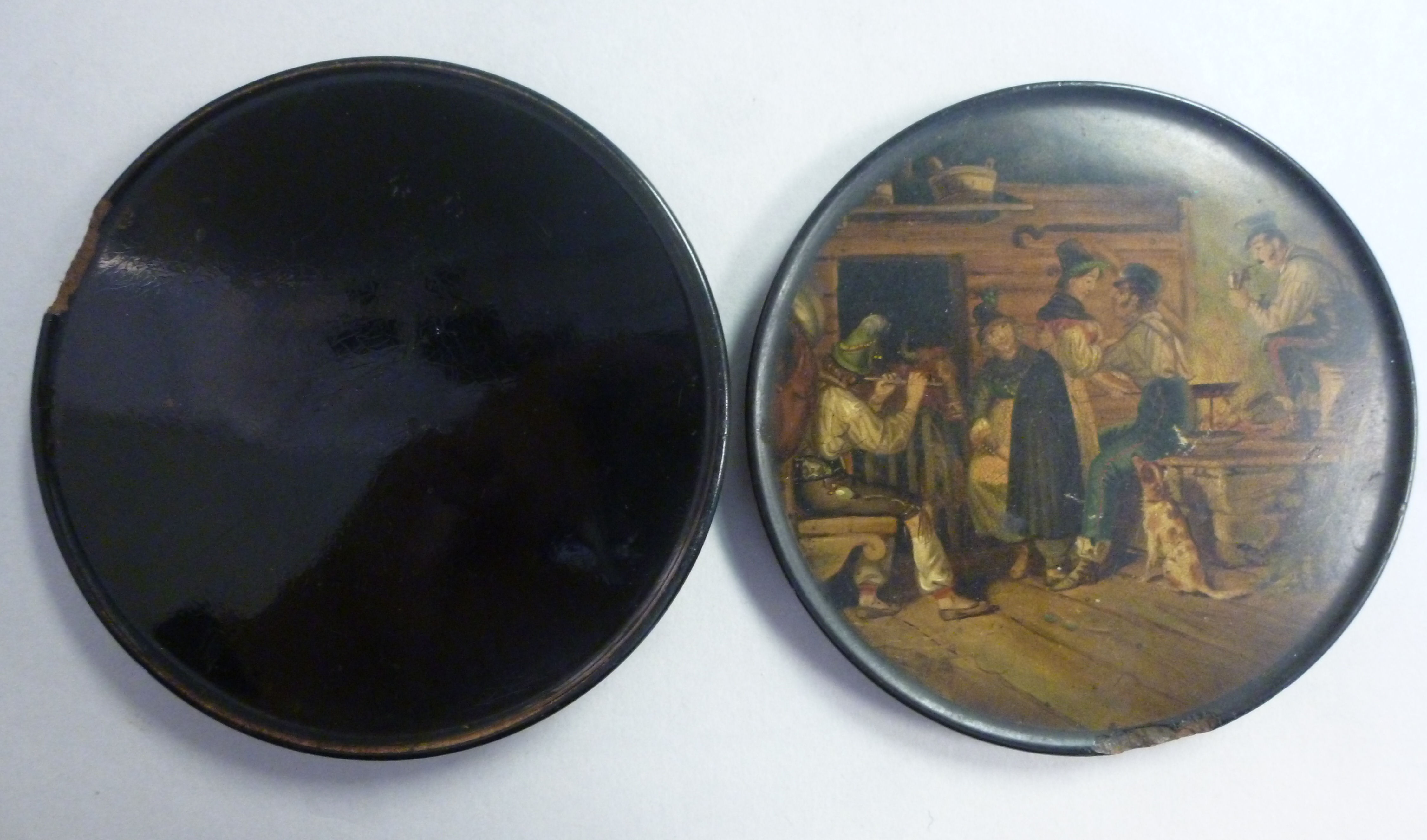 An early 19thC black lacquered papier mache shallow, circular snuff box,