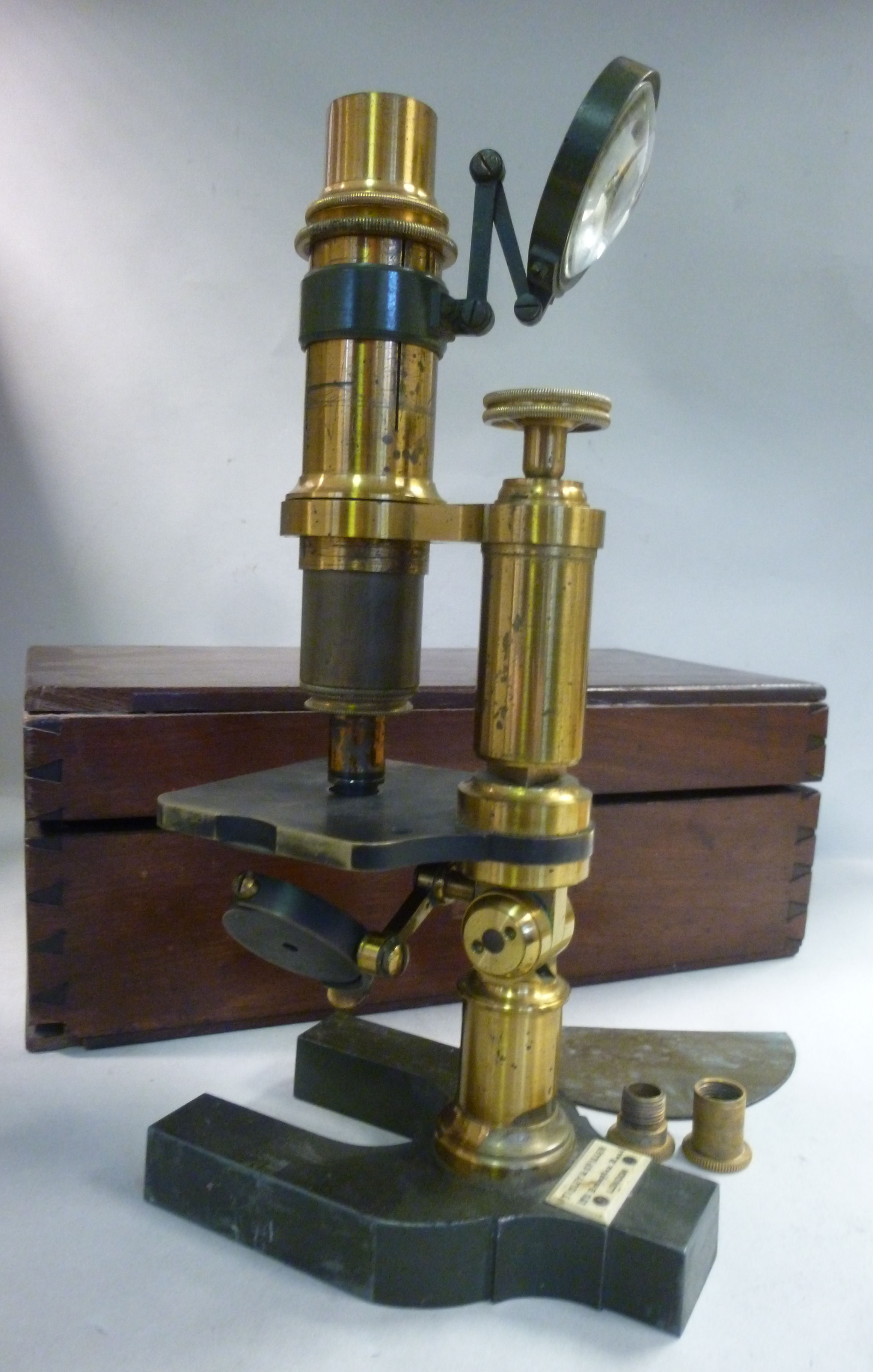 A late 19thC enamelled green steel and lacquered brass microscope (eyepiece missing) bears the