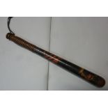 A late 19thC police wooden truncheon, painted in colours on black, impressed PC165, on a ribbed,