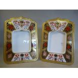 A pair of Royal Crown Derby bone china photograph frames on moulded stands,