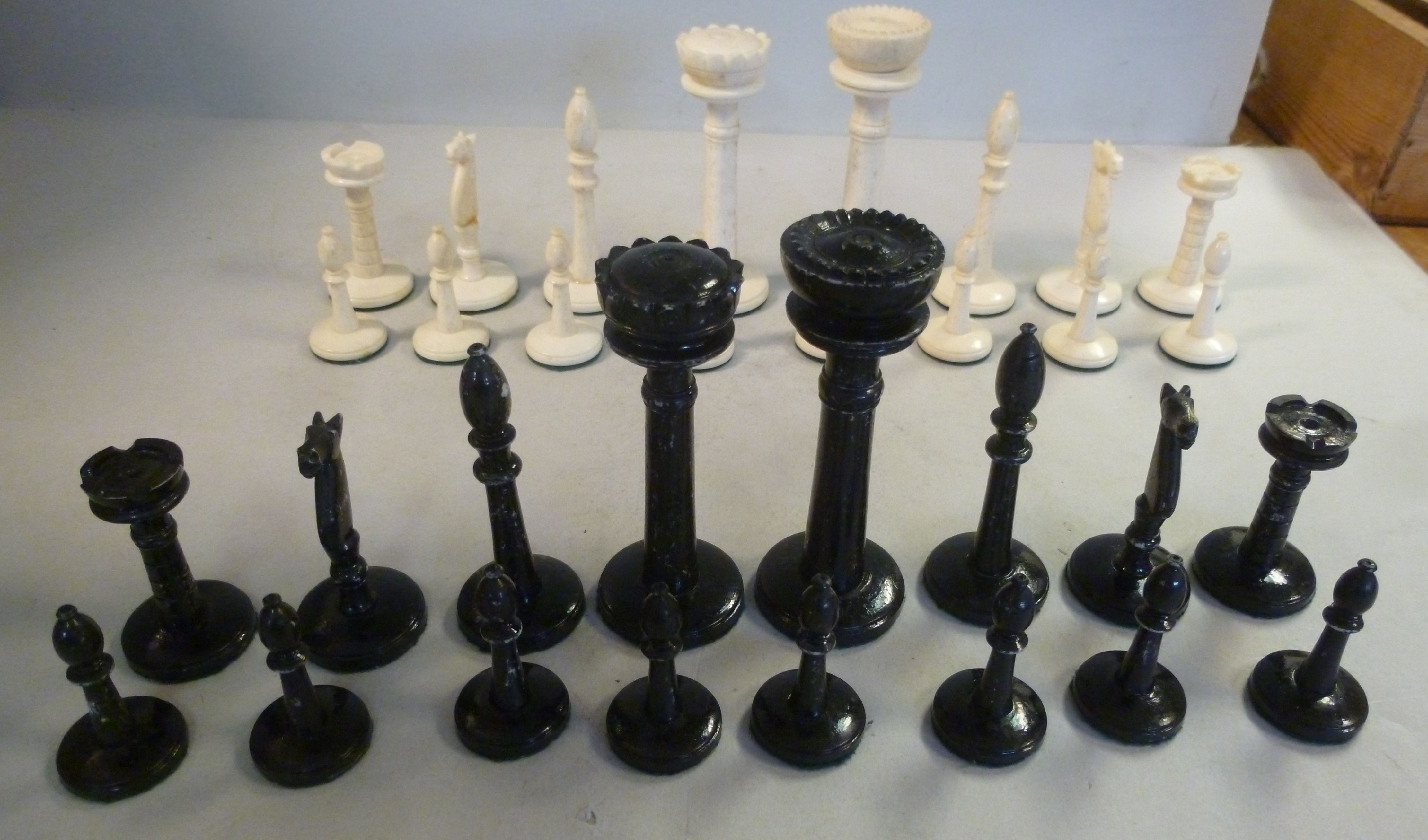 An early 20thC turned and carved bone, naturally coloured and black lacquered chess set, - Image 2 of 8