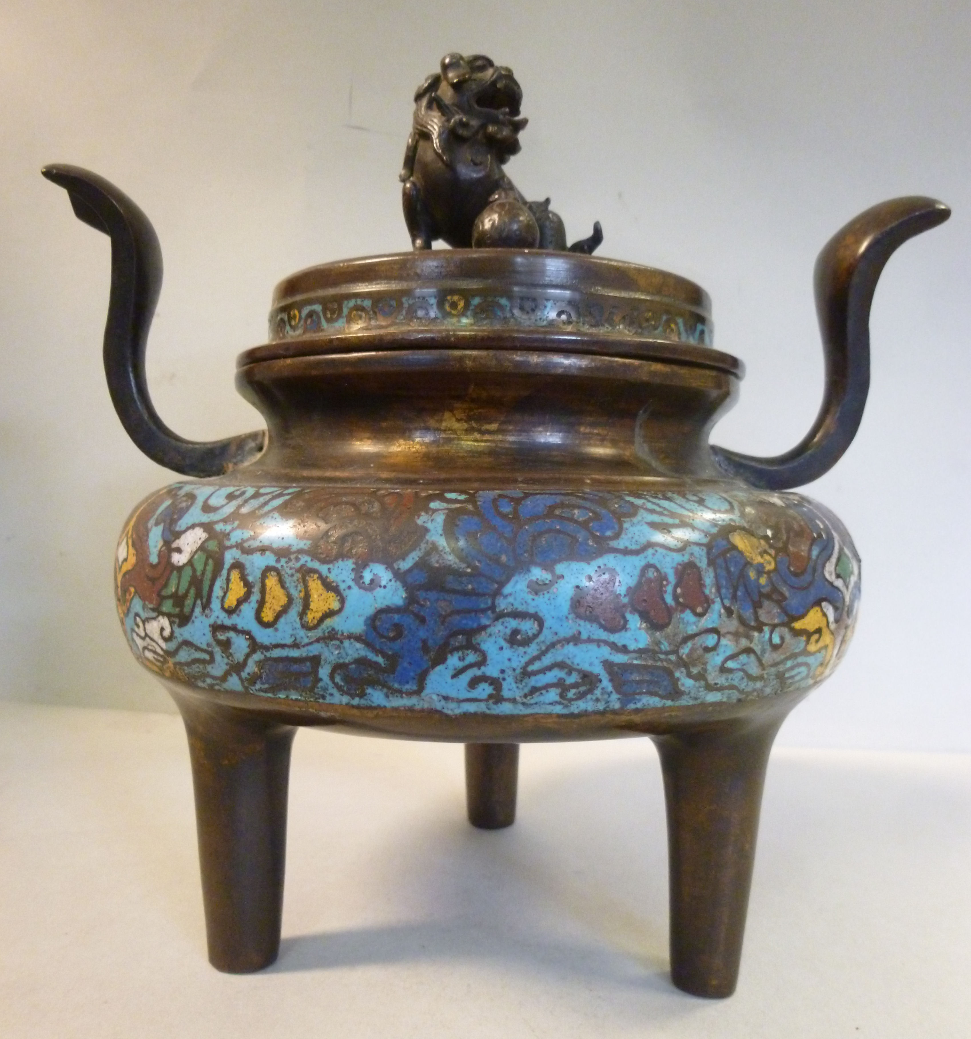 A 19thC Chinese twin handled brass censer with banded enamel ornament,