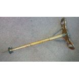 An Edwardian mahogany shooting stick with iron fittings and a tapered,