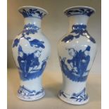 A pair of late 19thC Chinese porcelain vases of waisted baluster form, having flared rims,