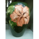 A Moorcroft pottery vase of ovoid form, decorated in tubeline, in a version of the Hibiscus pattern,